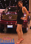 Girl at a car show posing with David's Escalade